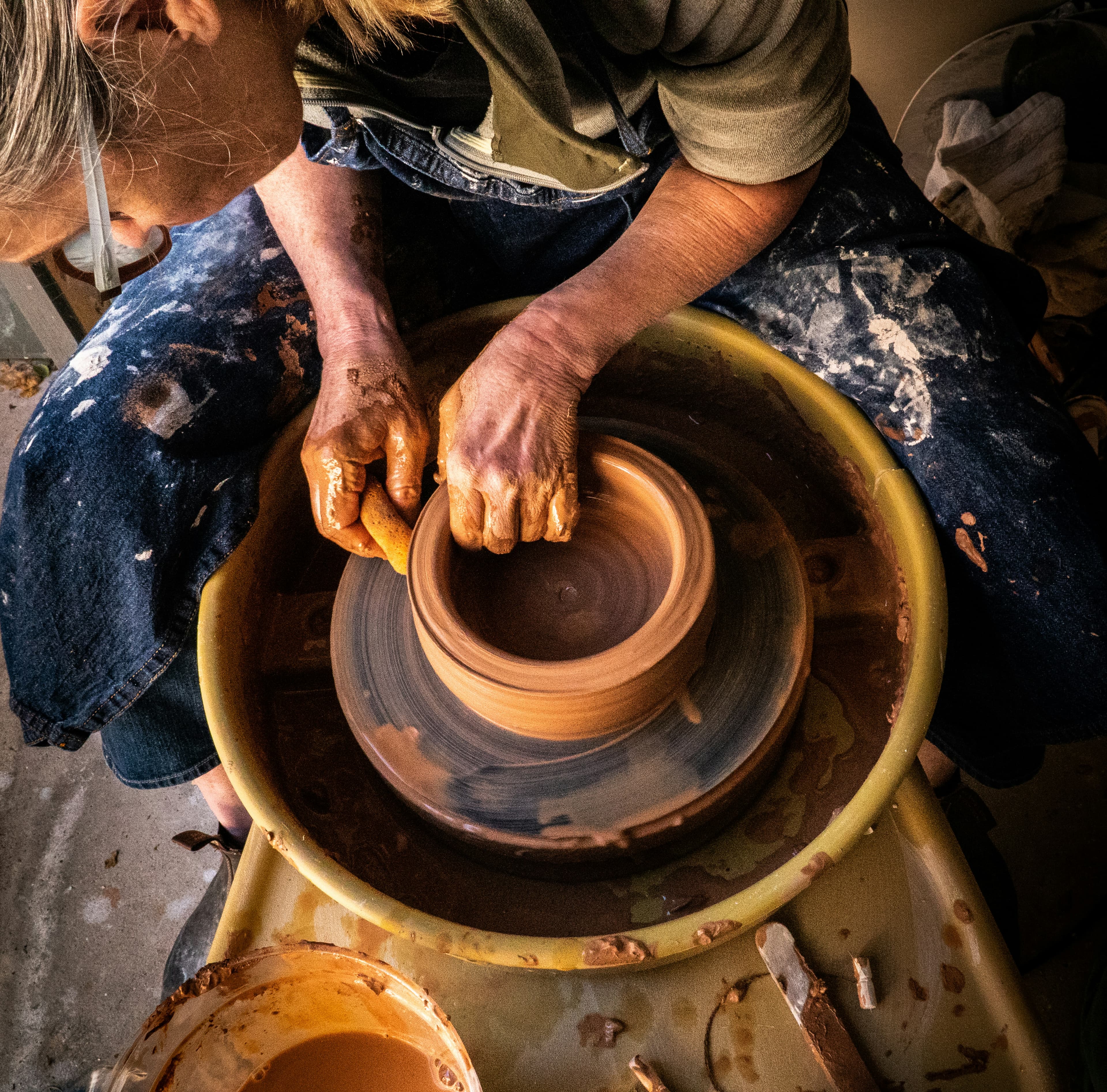 Pottery teacher working with children